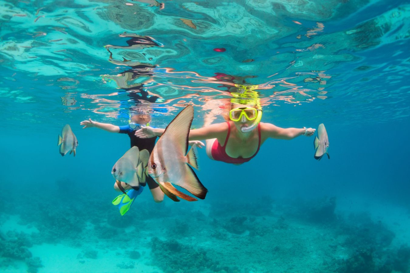 kids snorkeling in teal waters
